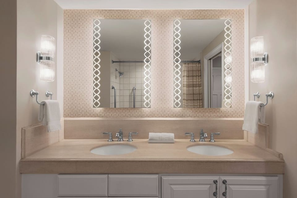 Refresh at a bright double vanity with spa-like lighting.