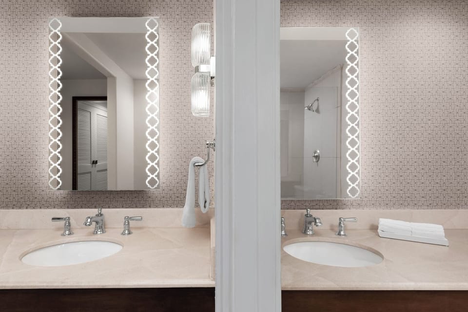 Refresh together at the double vanity with glowing mirrors.