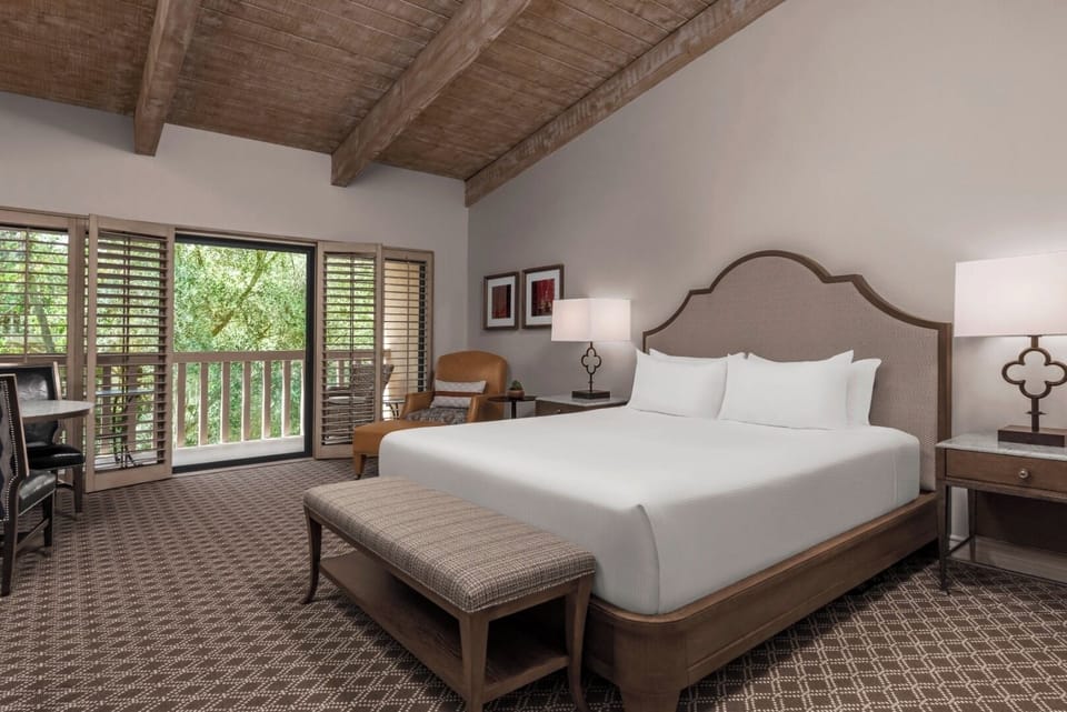 Sink into crisp linens beneath warm wood-beam ceilings.