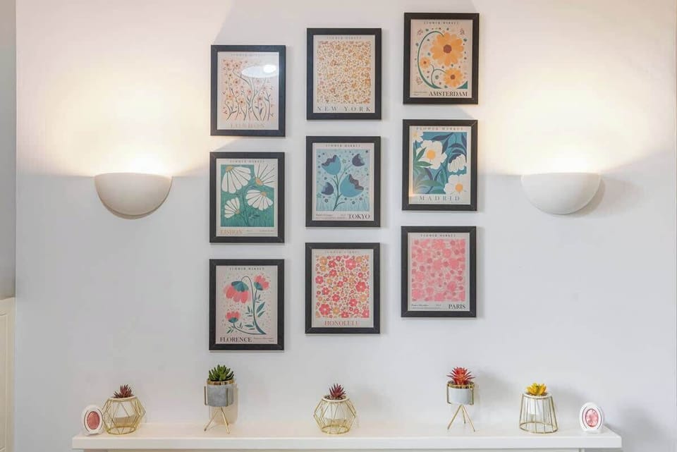 - Wall art gallery with framed prints and decor  
- Soft lighting enhances cozy indoor atmosphere  
- Stylish detail adds color and charm to space  