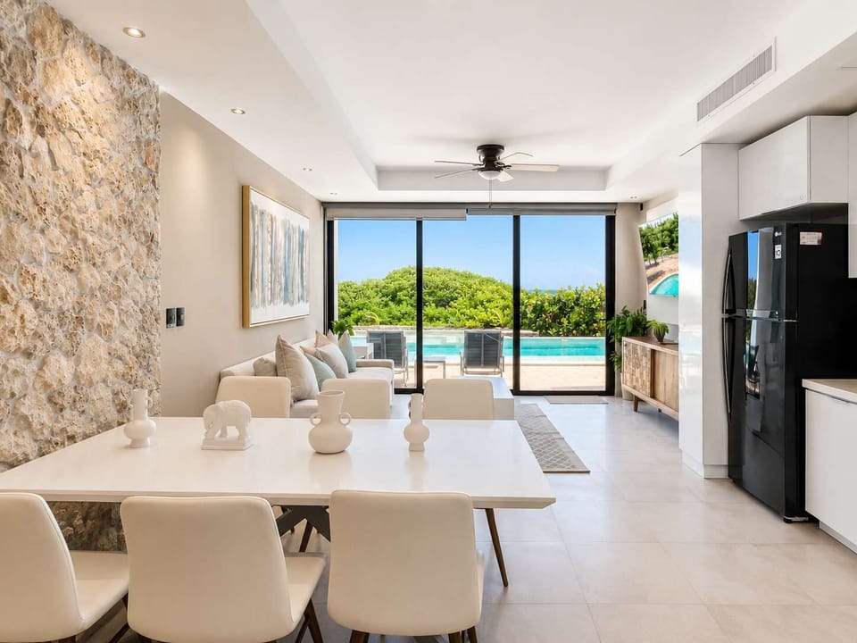 Open living and dining space with ocean view and full kitchen