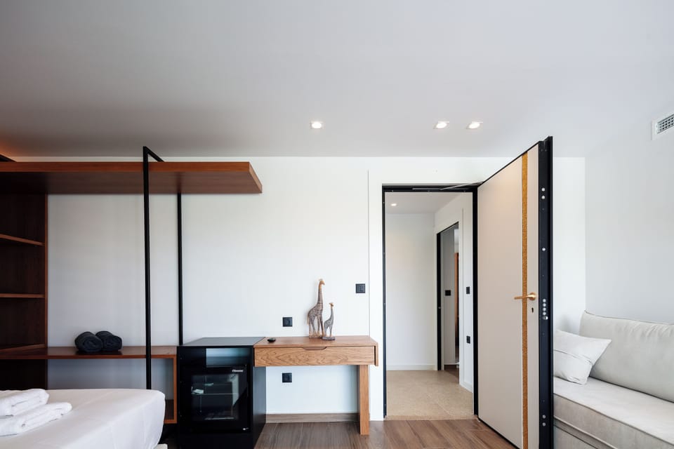 The fourth bedroom features a King-size bed (1,80 x 2,00), an open closet, a 43” TV, a mini fridge, an en-suite bathroom with a standup shower, and a picturesque balcony
The fourth bedroom features a King-size bed (1,80 x 2,00), an open closet, a 43” TV, 
