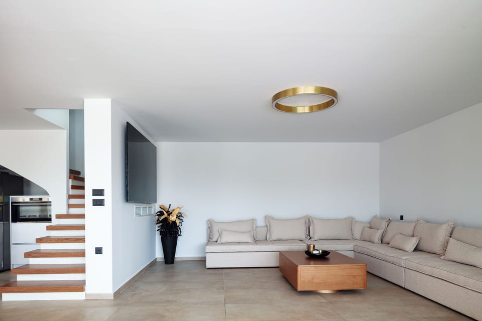 The living room boasts a sumptuous, oversized sofa, perfect for sinking into as you unwind, an impressive 86” TV, and a PlayStation 5 to enjoy all the fun!