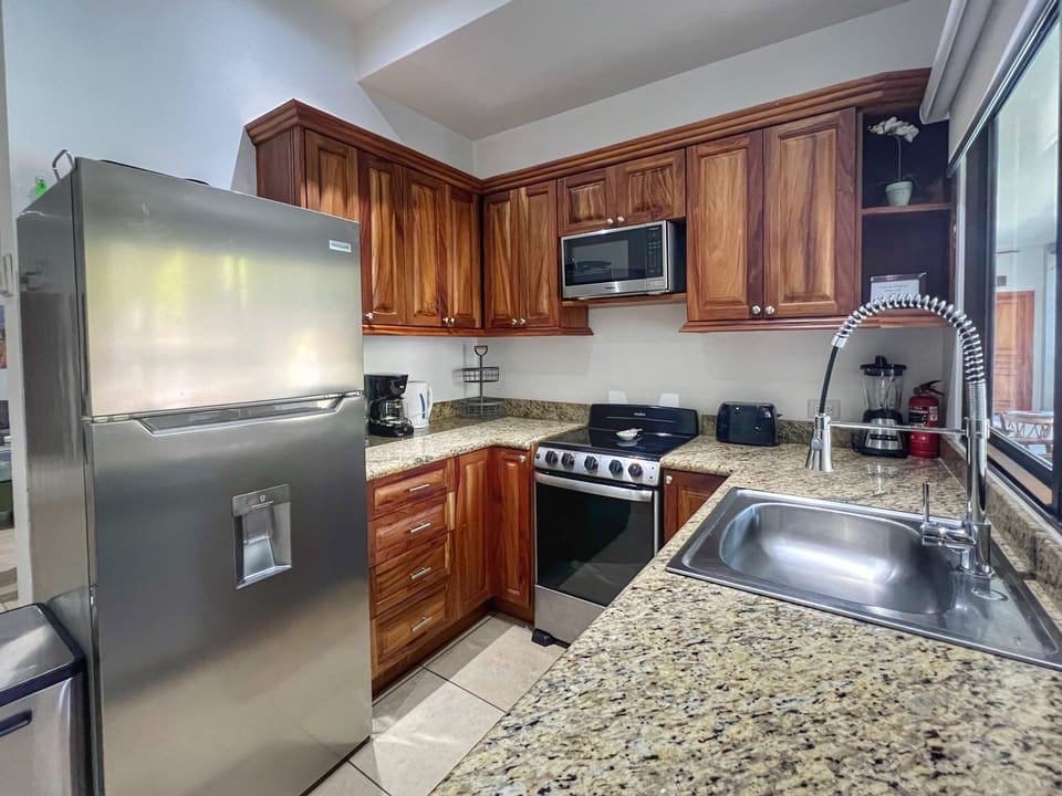 The condo has a well-equipped kitchen just inside the front door, then flows into the dining & living space.  
