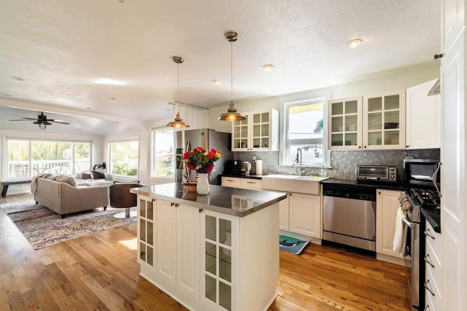 Bright open kitchen with a central island, modern appliances, and a seamless flow into the living area.
