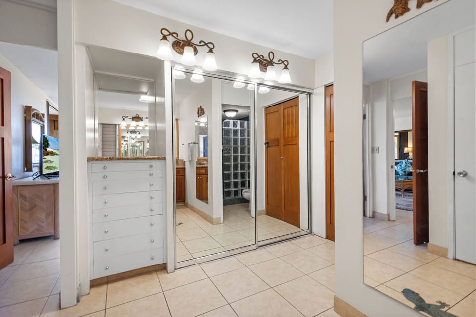 Bright vanity lights and mirrored closet doors reflect the spaciousness of your private suite, while elegant tile floors and generous storage keep your stay organized and comfortable.