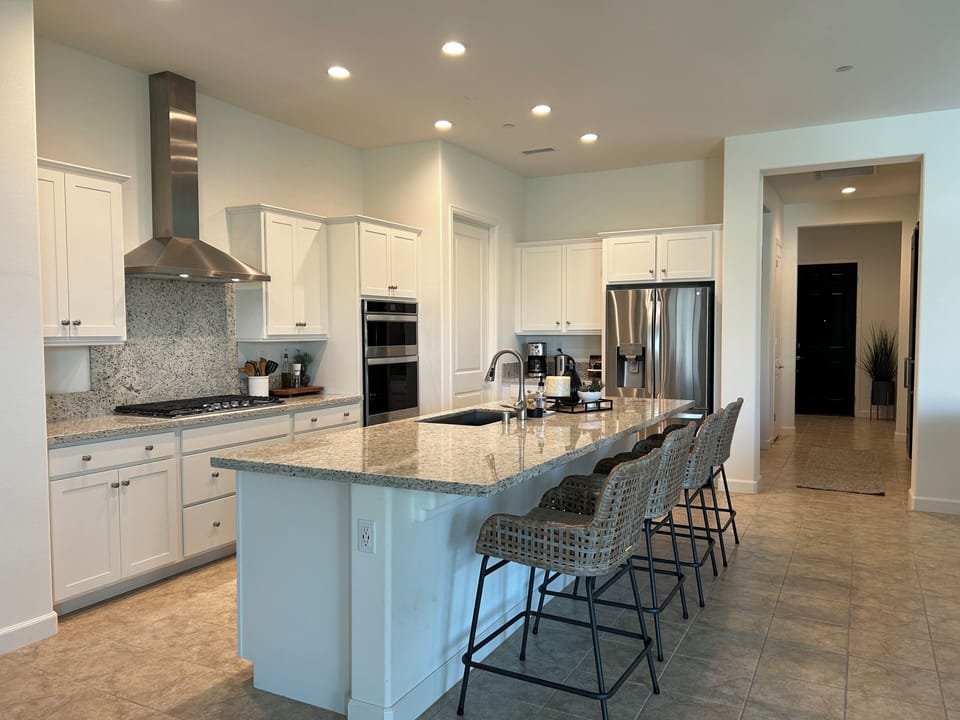 Door in kitchen leads into large walk in pantry. With extra items.