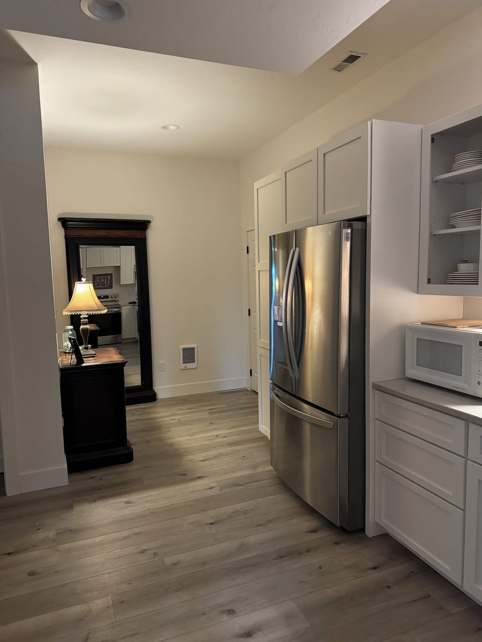 Kitchen and back hall with a full length mirror.