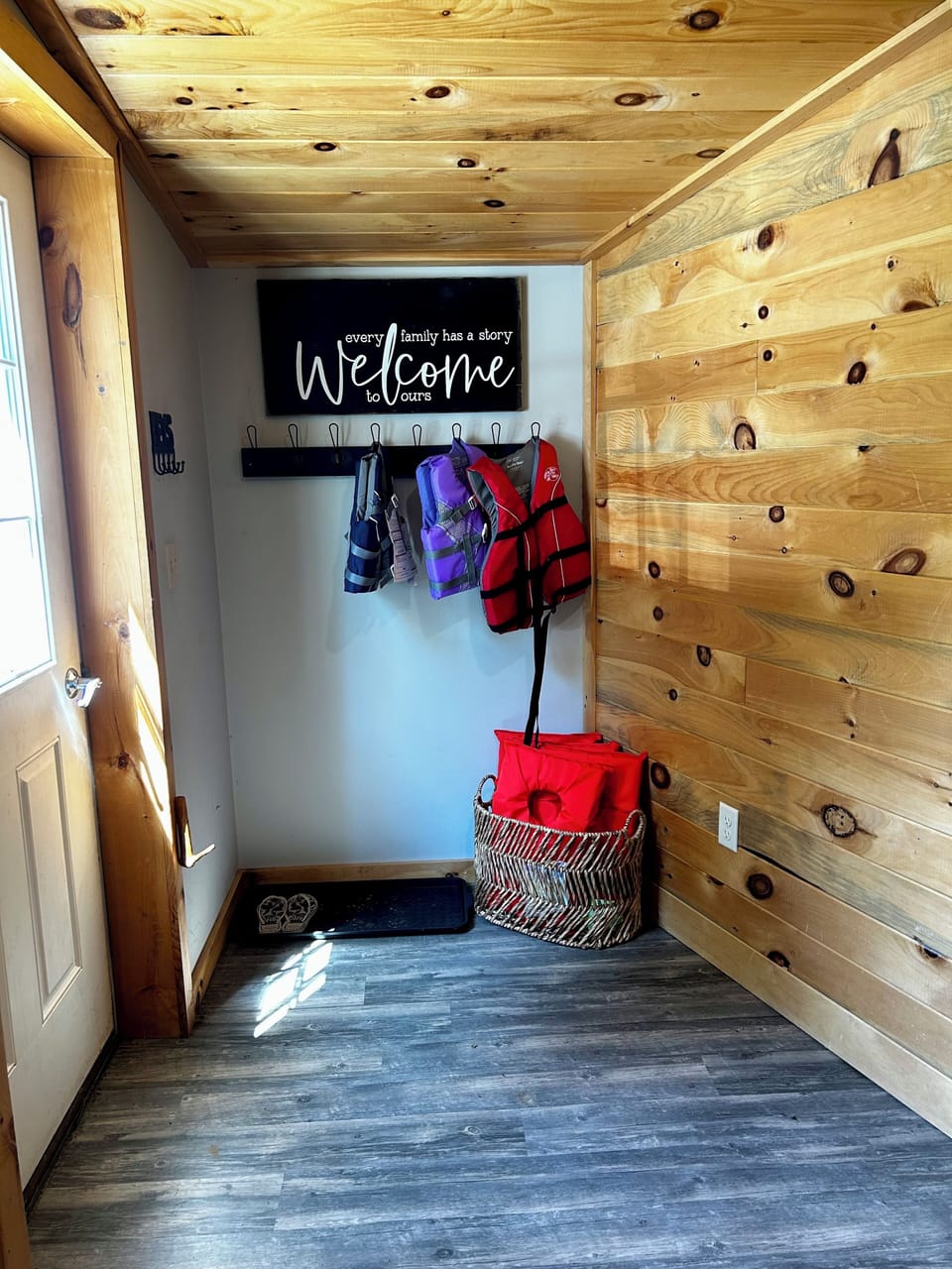 Entryway with life jackets and hooks.