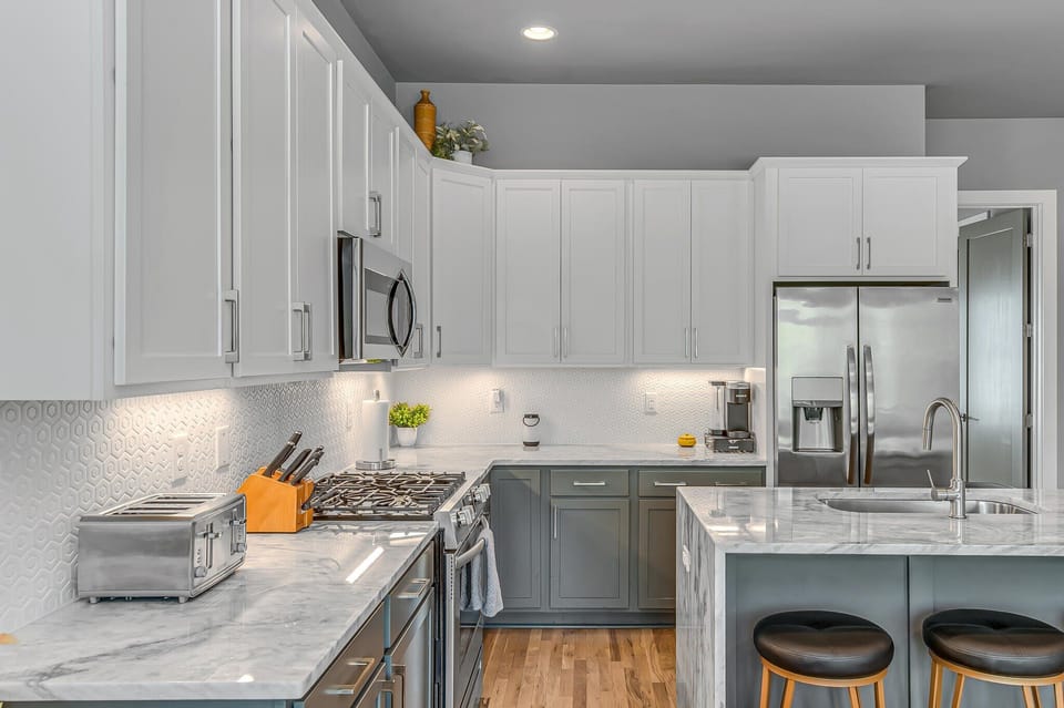 2nd Floor: Fully equipped kitchen featuring stainless steel appliances and bar seating.