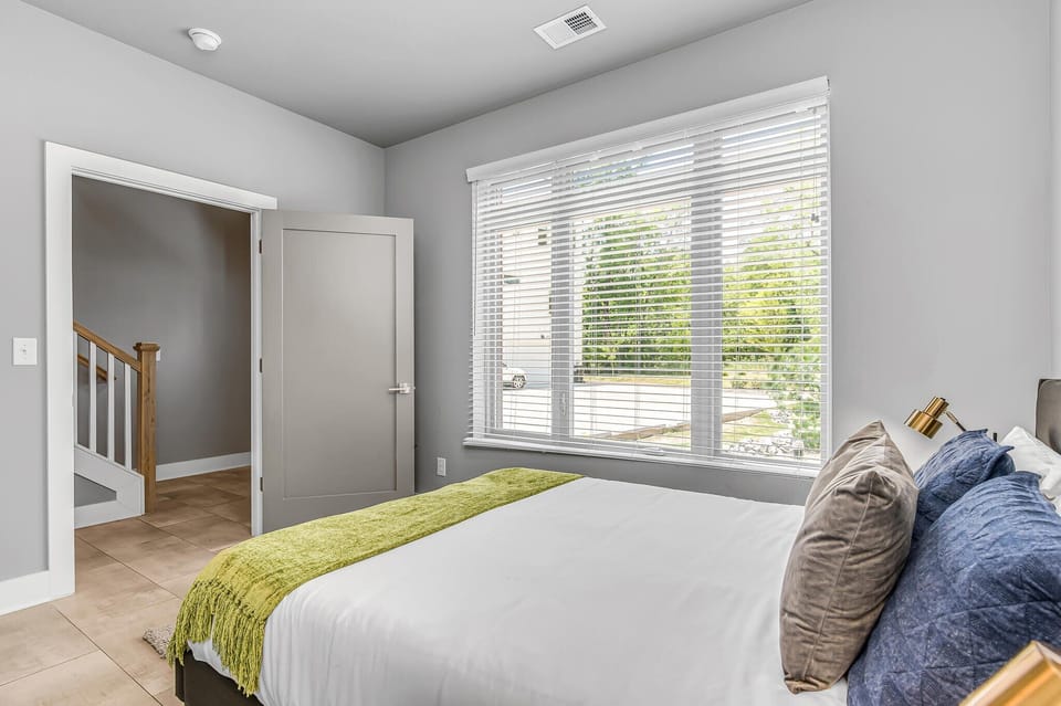 1st Floor: 4th Bedroom featuring a Queen Bed, Smart TV, and En-Suite Bathroom.