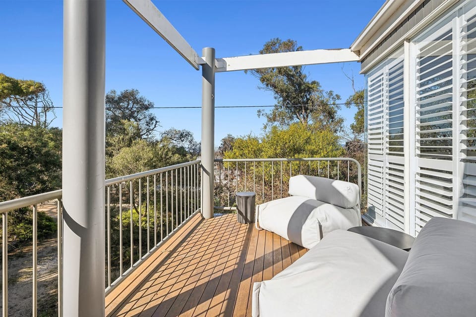 Wake up to ocean views and enjoy your morning coffee on a deck that feels like it floats above the treetops