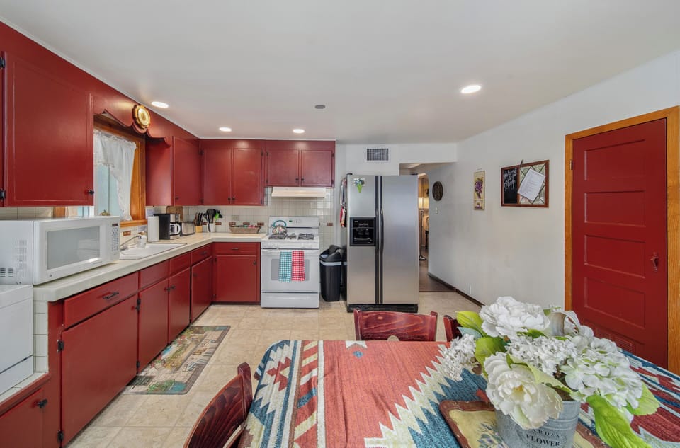 View of our large kitchen from dining room table, including the fridge/freezer.