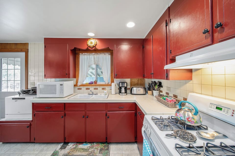 Large kitchen: fridge/freezer, oven, microwave, coffeemaker, small dishwasher.