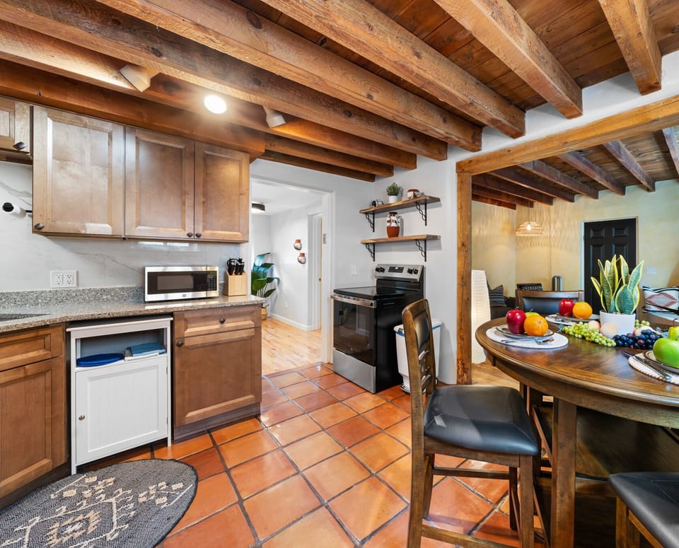 Rustic kitchen with granite countertops and wooden cabinets.