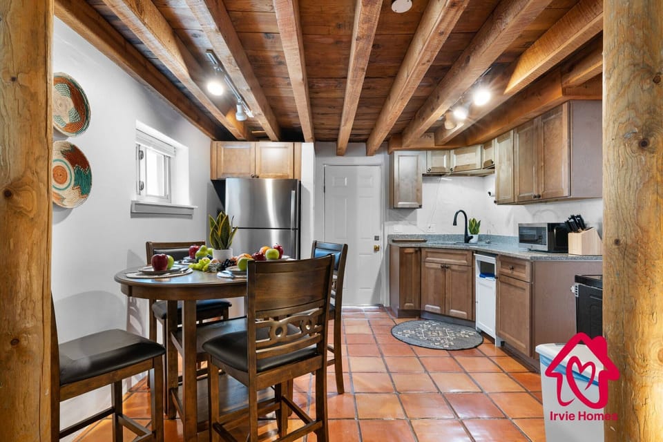 Cozy kitchen with terracotta tiles and wooden beams.