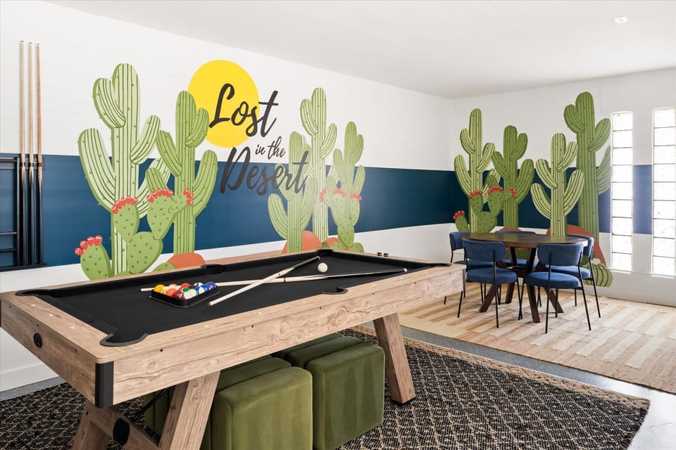 Game room with pool table, foosball, poker table, smart TV, and bunk beds.