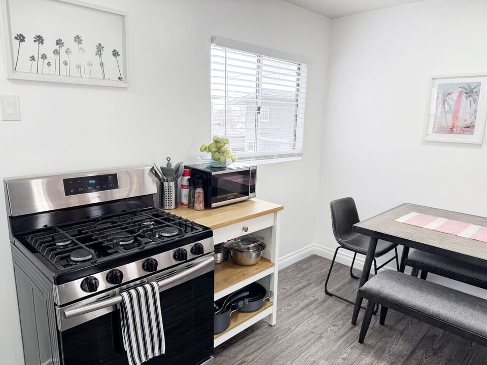 Casual dining area with a bench-style table for four, plus extra kitchen prep space and all the cookware you need.