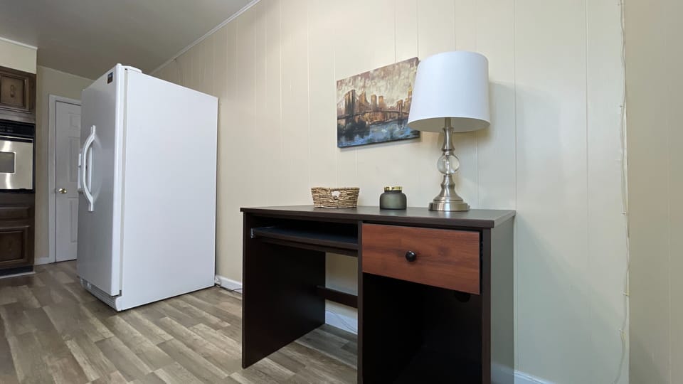 Function meets convenience!  A spacious fridge and a sleek desk create the perfect blend of practicality and comfort.