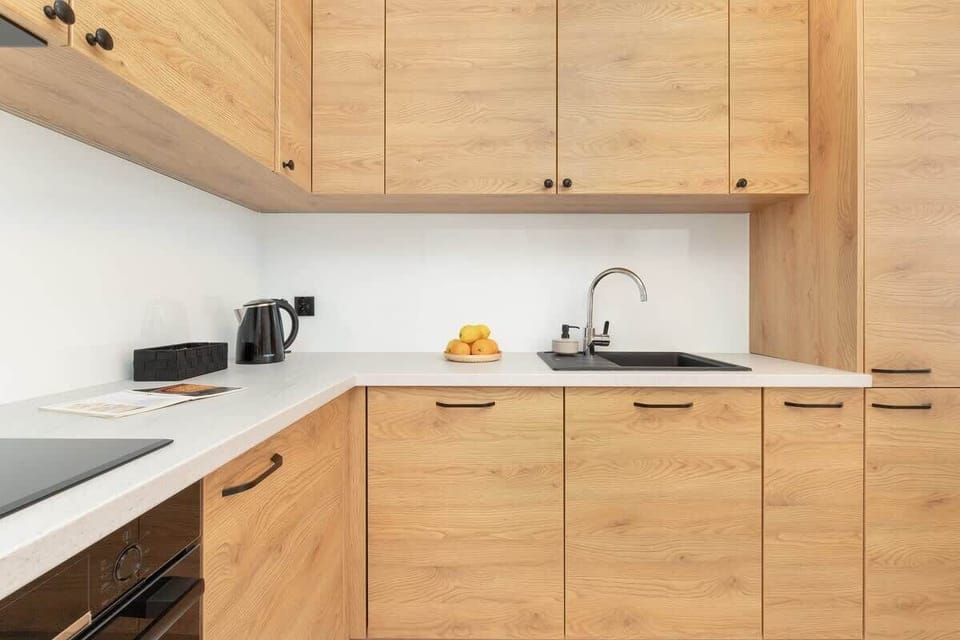 The sleek design of the kitchenette blending seamlessly with the living area.