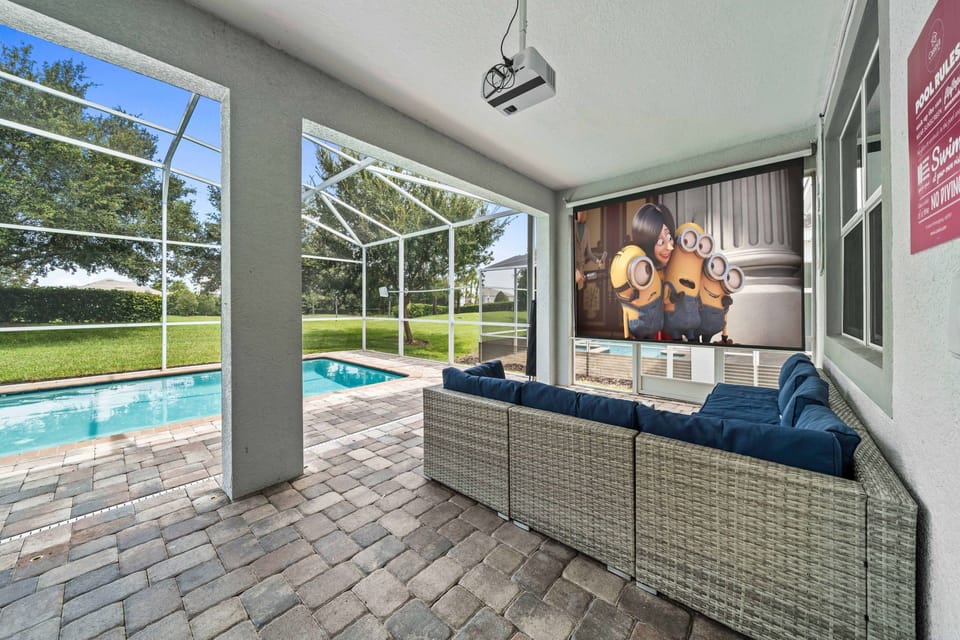 - Outdoor lounge area is a perfect spot for movie nights or simply relaxing, featuring a large screen projector - The space is adjacent to a private pool with a screened enclosure - Cozy seating, modern amenities, and the beautiful outdoor setting