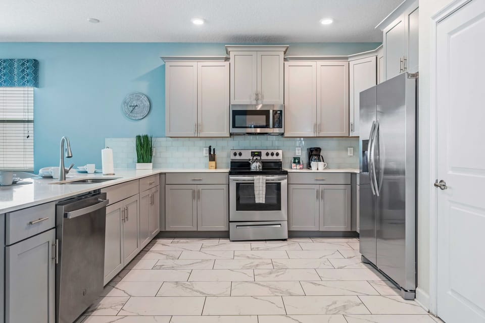 - Kitchen features a modern design with plenty of storage and counter space, perfect for preparing meals  - Integrated appliances contribute to the seamless and stylish appearance - Kitchen essentials are thoughtfully placed for easy access