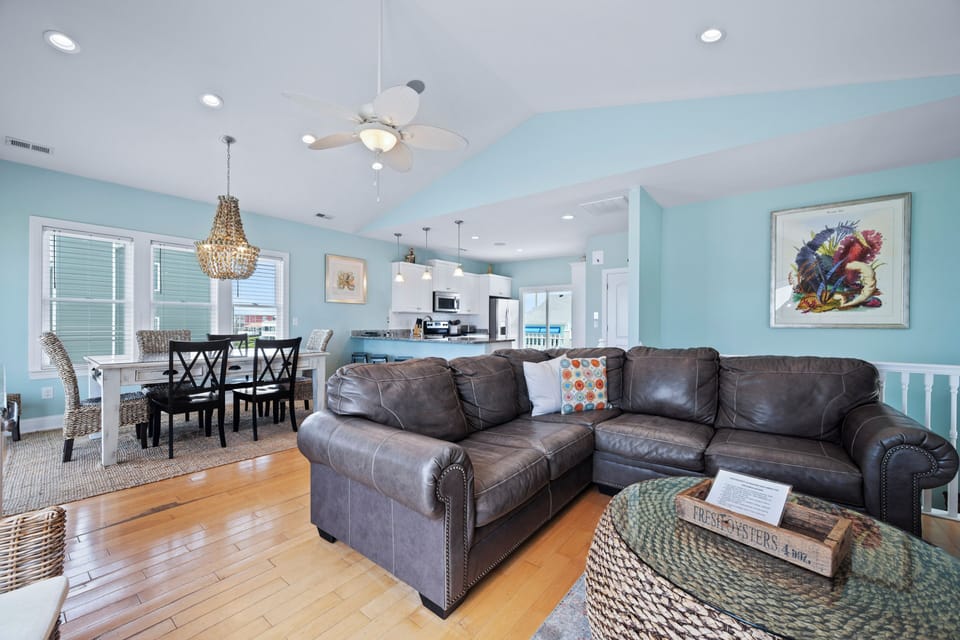 Gather in this airy, open-concept space where coastal colors meet cozy seating. The spacious living and dining area flows seamlessly into the kitchen—perfect for quality time together.