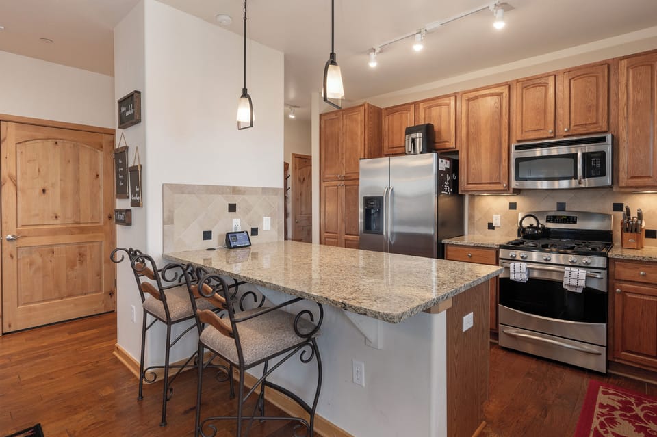 - Granite island with bar seating for two and stylish pendant lighting above - Great for casual dining, morning coffee, or chatting with the chef while cooking -