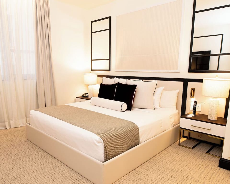 Unwind in a crisp, sunlit room with plush linens.