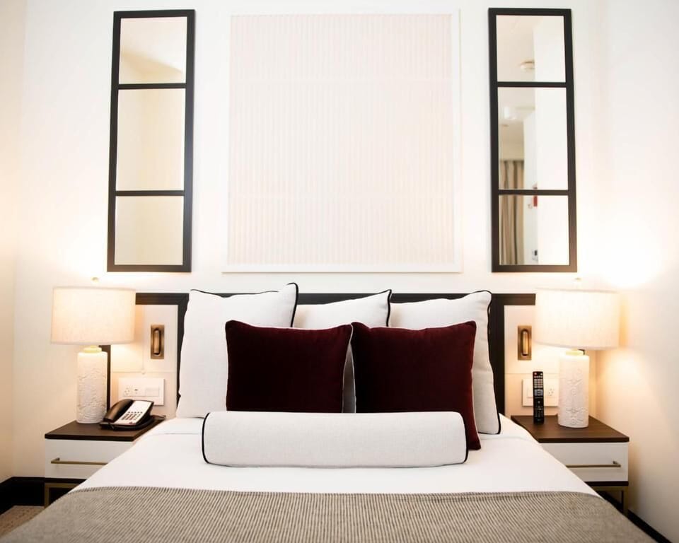 Drift off in crisp linens beneath warm bedside lighting.