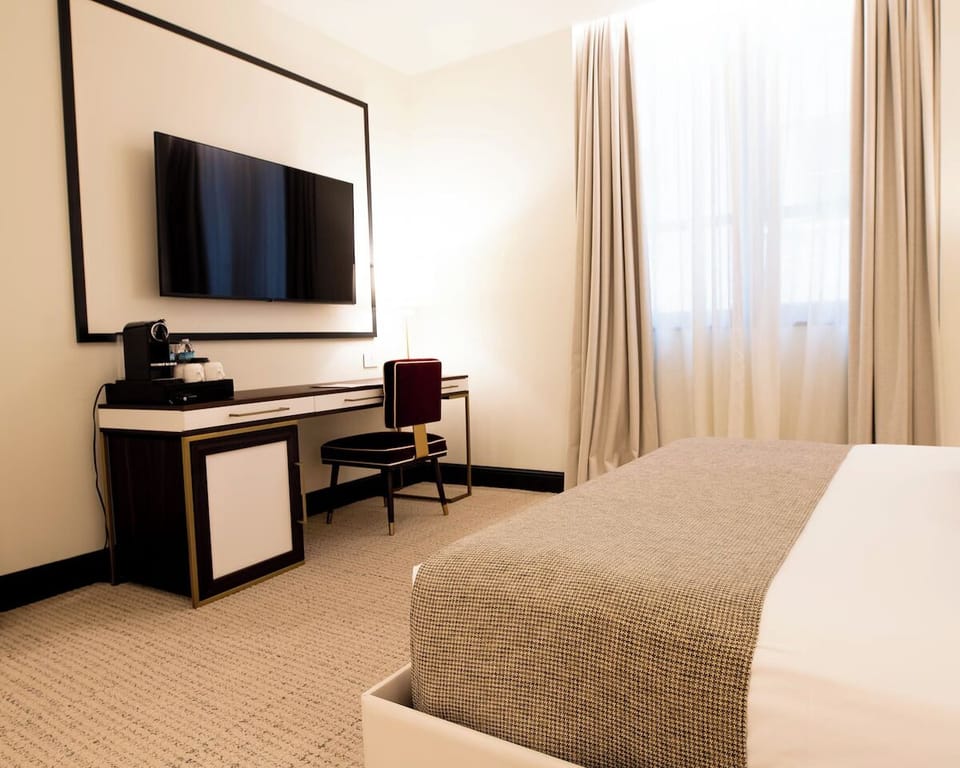 Catch up on work at a sleek desk with streaming-ready TV.