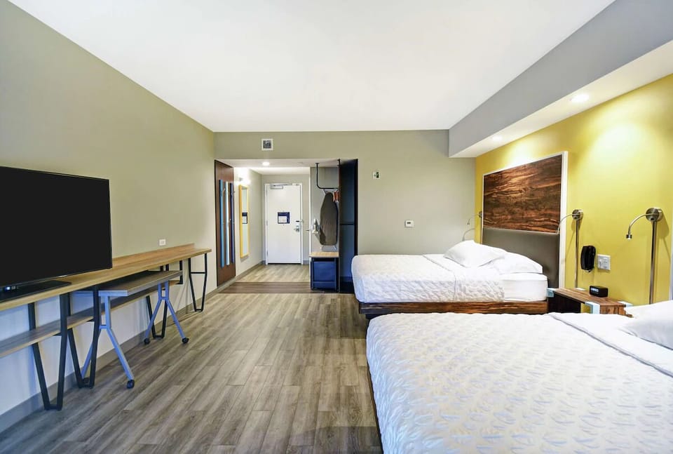 Unwind in a spacious double-queen room with modern comforts.