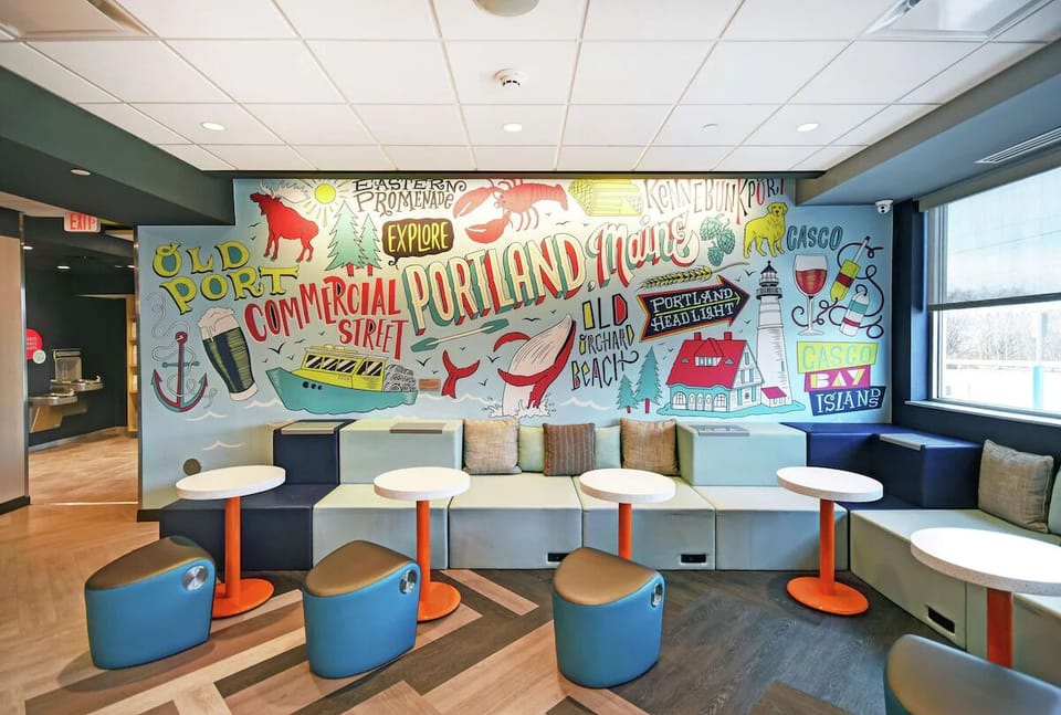 Relax beneath vibrant local art in a comfy conversation corner.