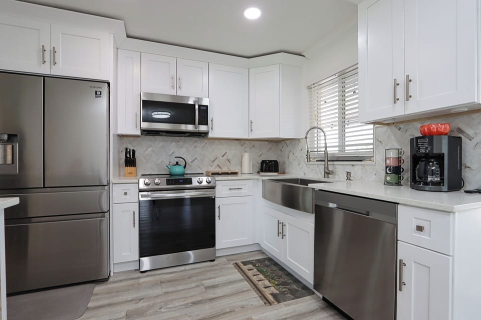 Enjoy cooking and connecting in this bright, modern kitchen with stainless steel appliances and views into the cozy living area