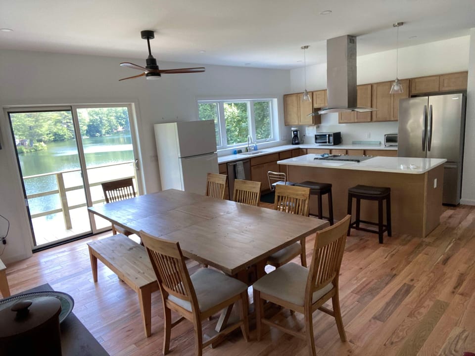 New kitchen w/ lake view, deck access, large island, dining rm table seats 10