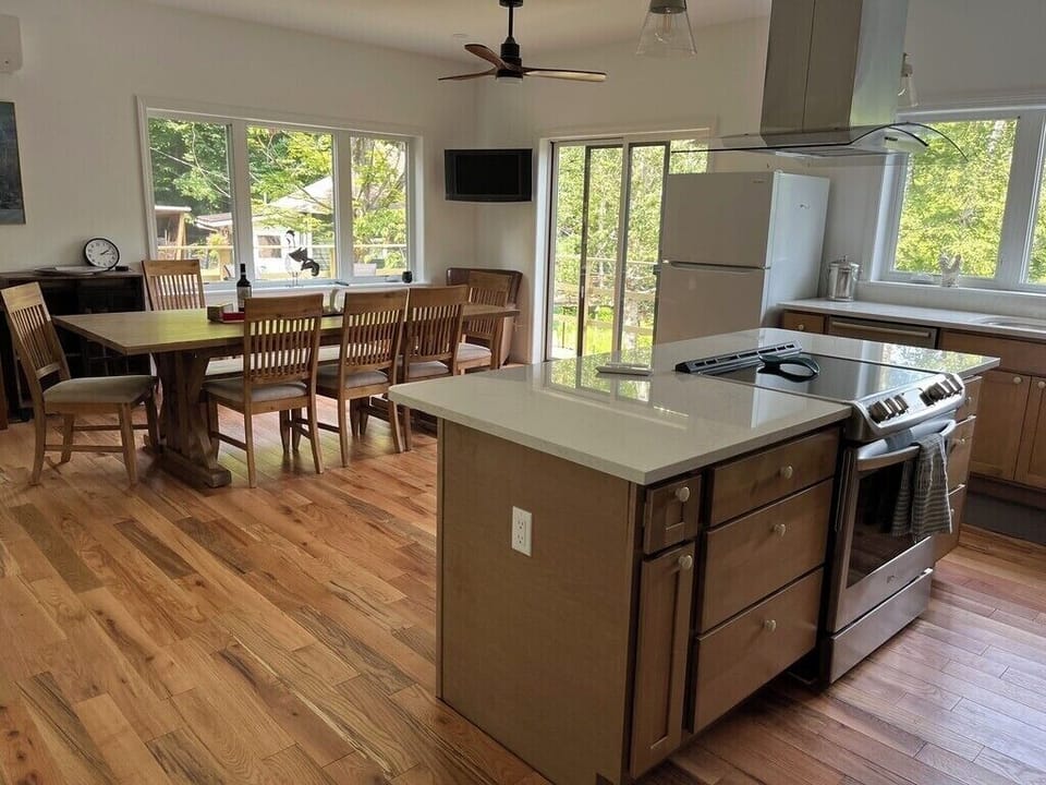 New kitchen w/ lake view, deck access, large island, dining rm table seats 10