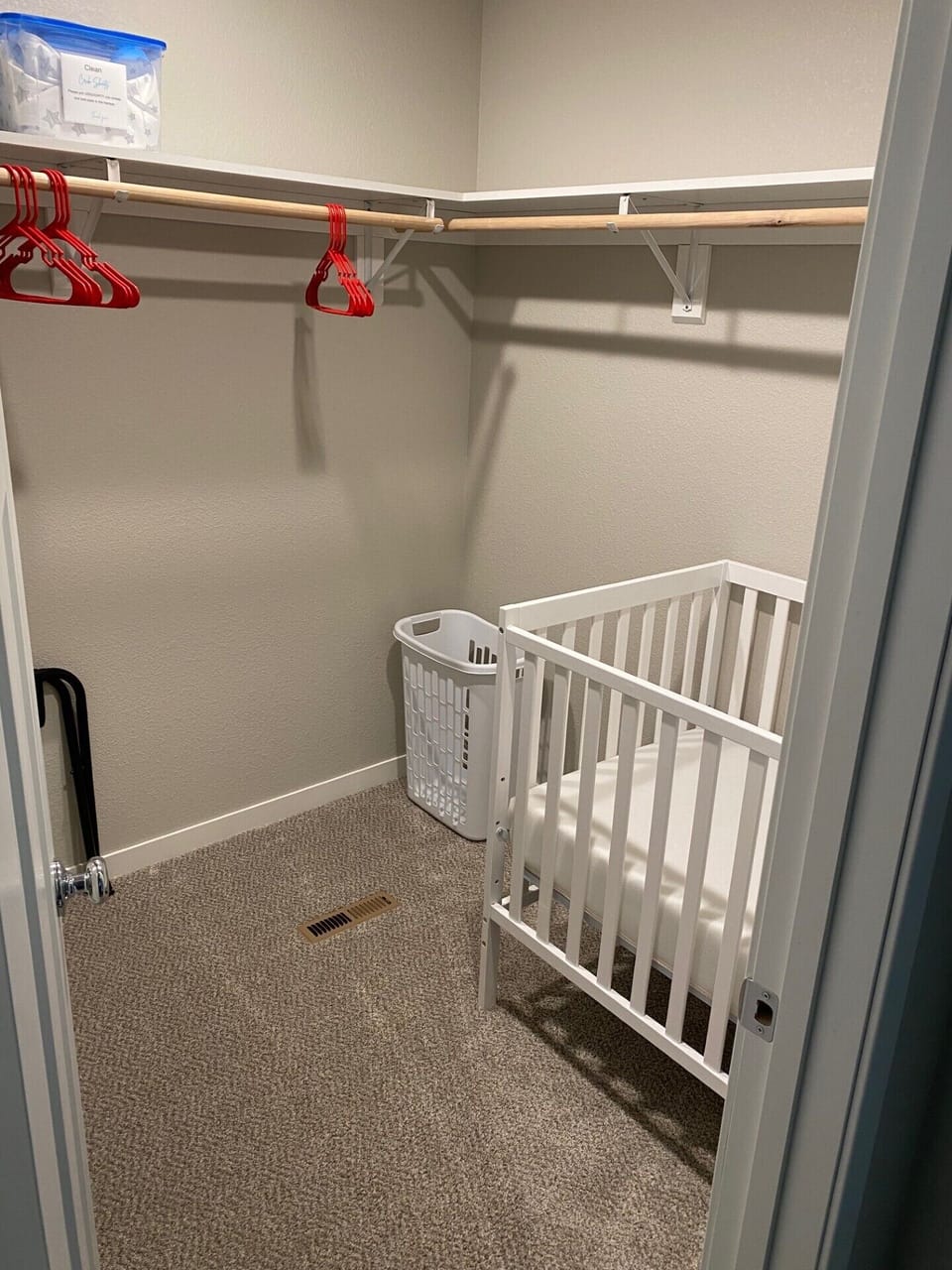 Main bedroom walk-in closet with full-size crib
