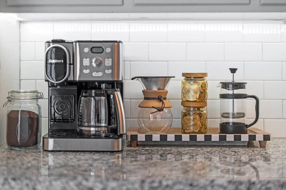 Thoughtfully stocked coffee station with drip, K-Cup, French press, pour over, coffee grounds, sugar and creamer to start your mornings right.