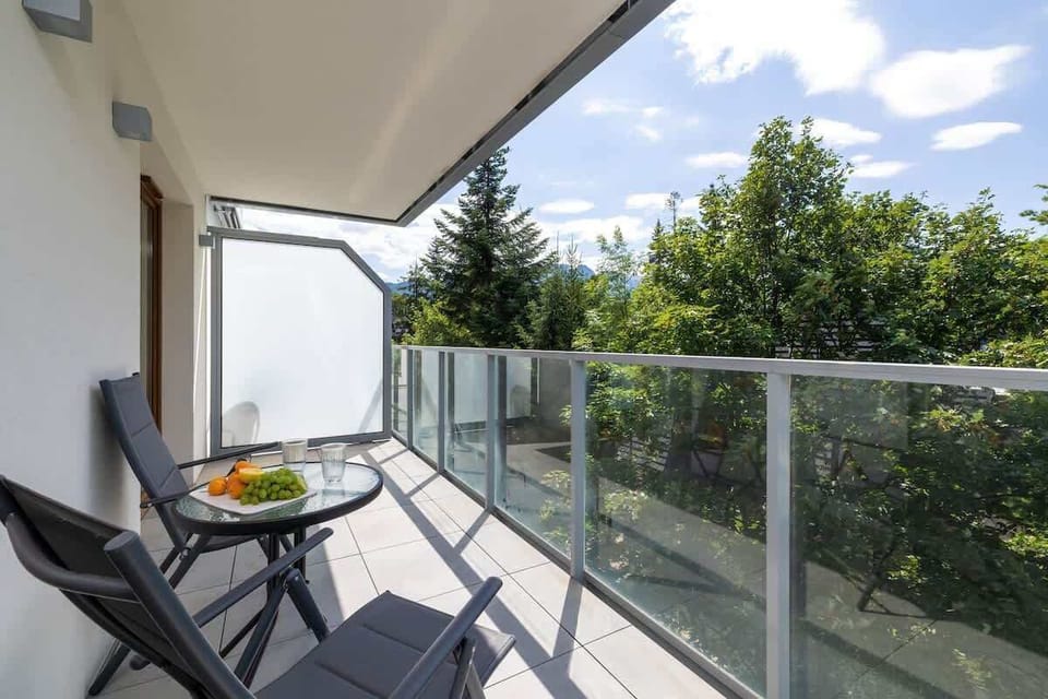 The balcony's stylish design complements the apartment's decor. 