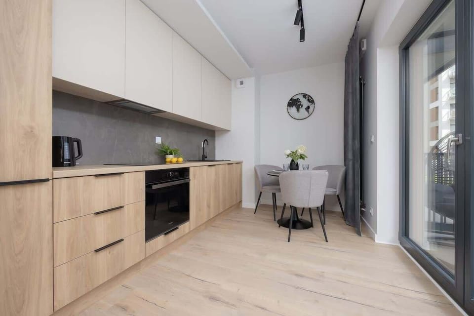 A wide kitchen view with modern cabinetry, built-in appliances, and plenty of counter space. Ideal for long or short stays.