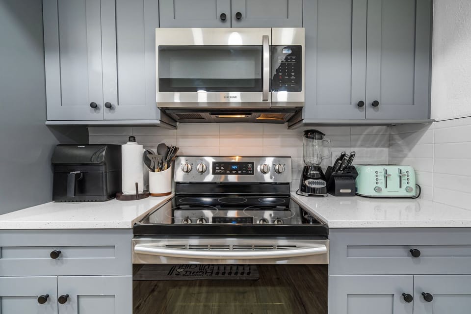Cook with ease in the fully equipped modern kitchen, featuring stainless steel appliances, air fryer, blender, toaster, and all the essentials. This Largo Florida vacation rental makes family meals simple, fun, and stress-free.