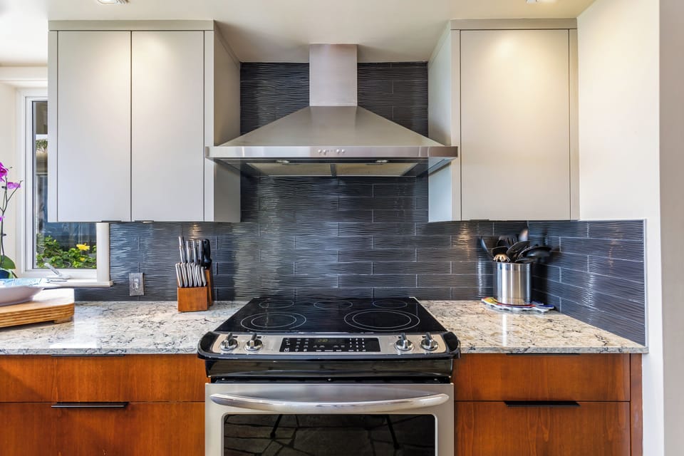 Prepare your favorite meals in this modern kitchen with sleek granite countertops, stainless-steel appliances, and contemporary finishes that make cooking a pleasure.