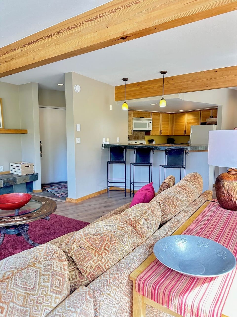 View of living room and kitchen with bar stools
