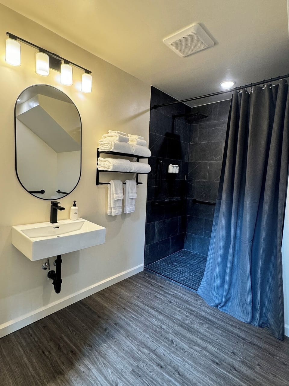 Large cabin bathroom that is equipped with a stylish light-colored sink, complemented by a black faucet.