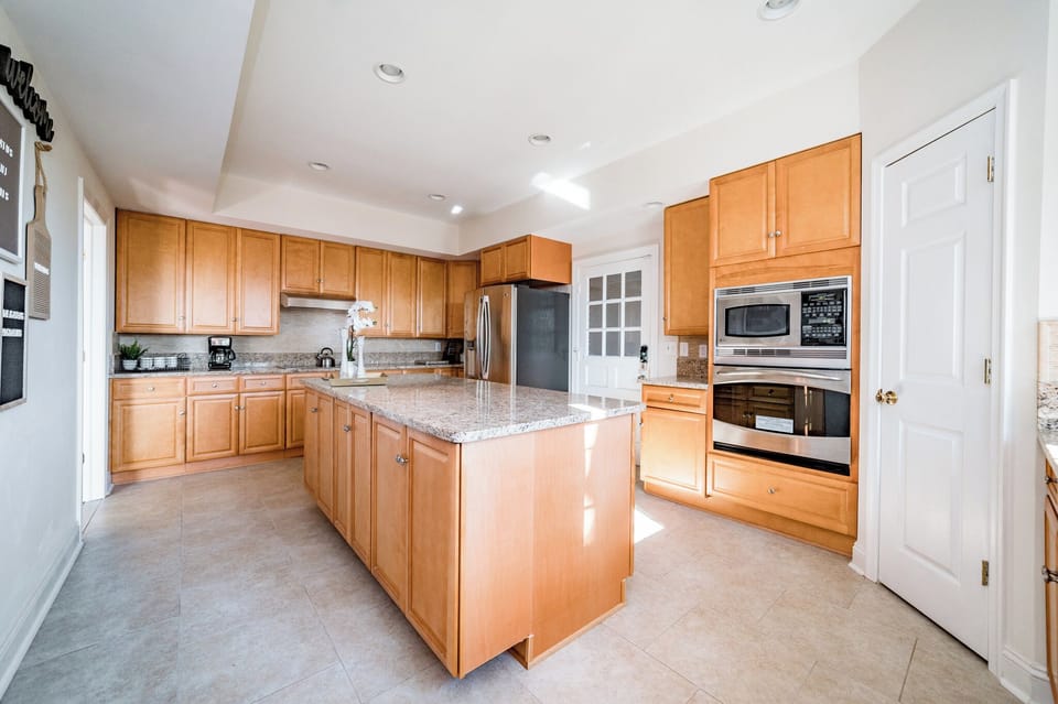 Stainless appliances include microwave, oven, stovetop, fridge, and dishwasher