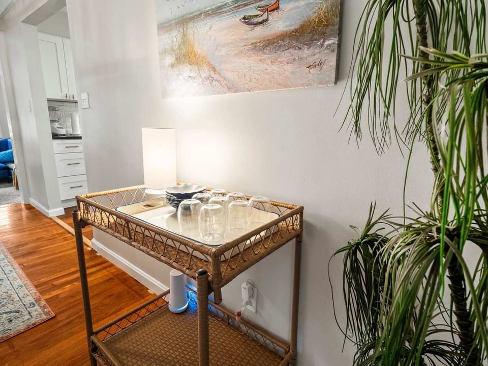 Bright entry table w/ wood top & simple decor, creating a warm welcome