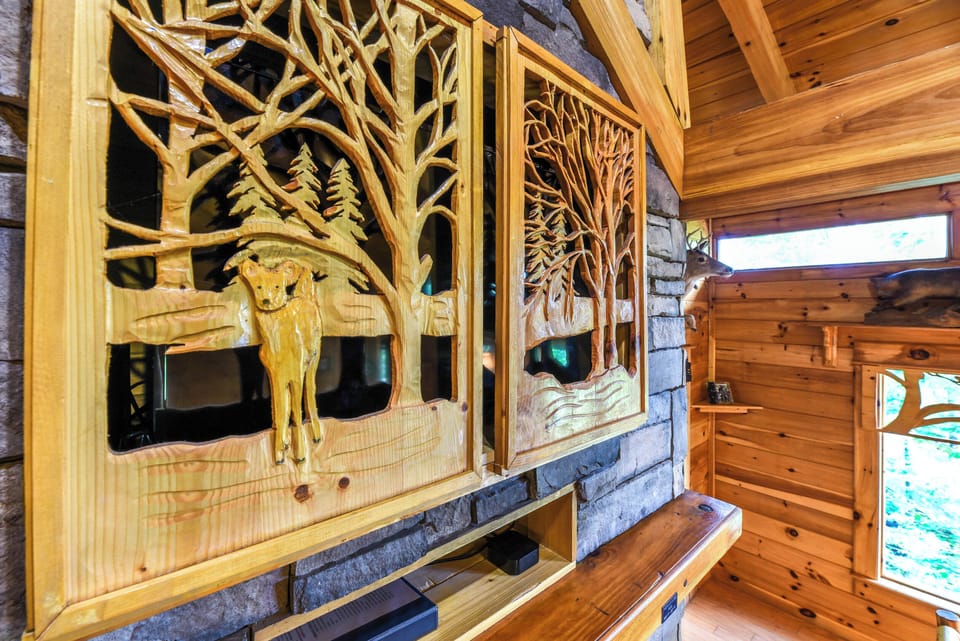 One of a kind hand carved doors cover the HDTV on the two story gas fireplace!