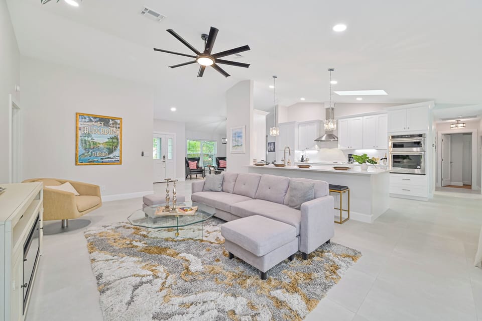 Bonita Vanderbilt - Living with electric fireplace and smart TV. Sliding doors open up to the screened in pool area
