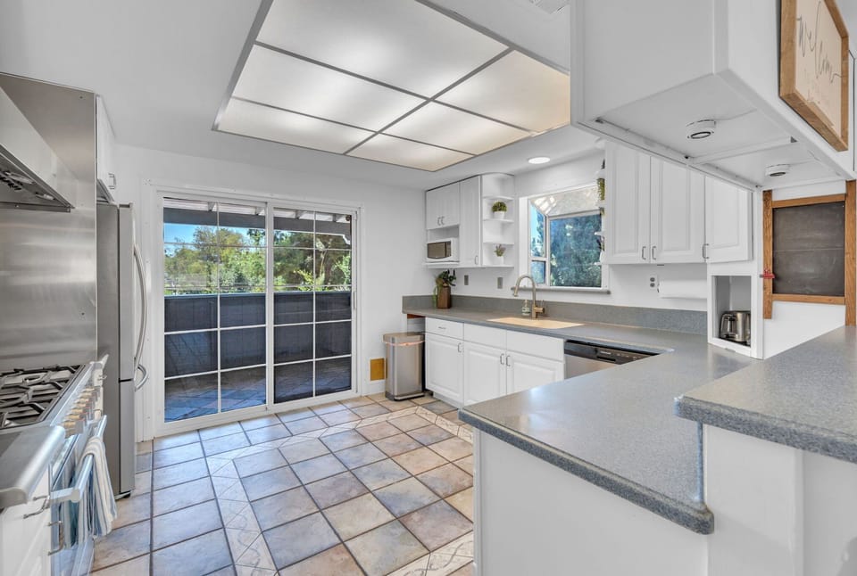 Prepare meals with ease in a sleek, fully-equipped kitchen featuring modern appliances, ample counter space, and a functional layout for cooking and entertaining.