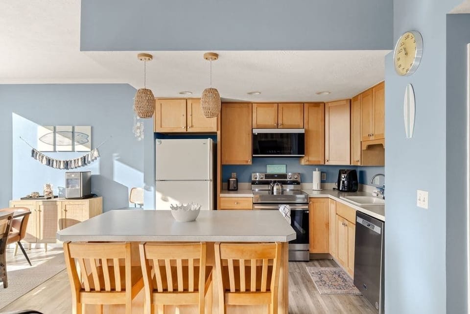 Fully equipped kitchen with island seating, modern appliances, and bright open layout for easy meals.